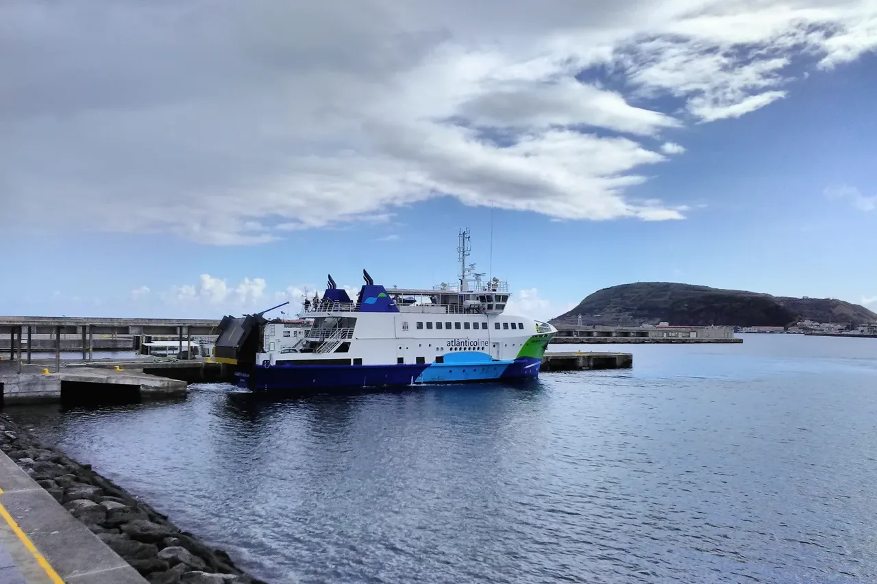 The white Atlânticoline car ferry Gilberto Mariano moored at the maritime terminal in Horta, Faial