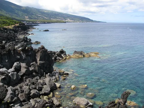 Lava rock coastline at Piedade, with Pico's volcano behind.